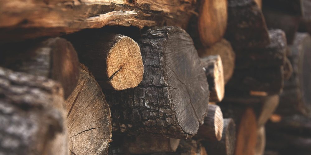 Detailed view of stacked chopped wood showing texture and warmth.